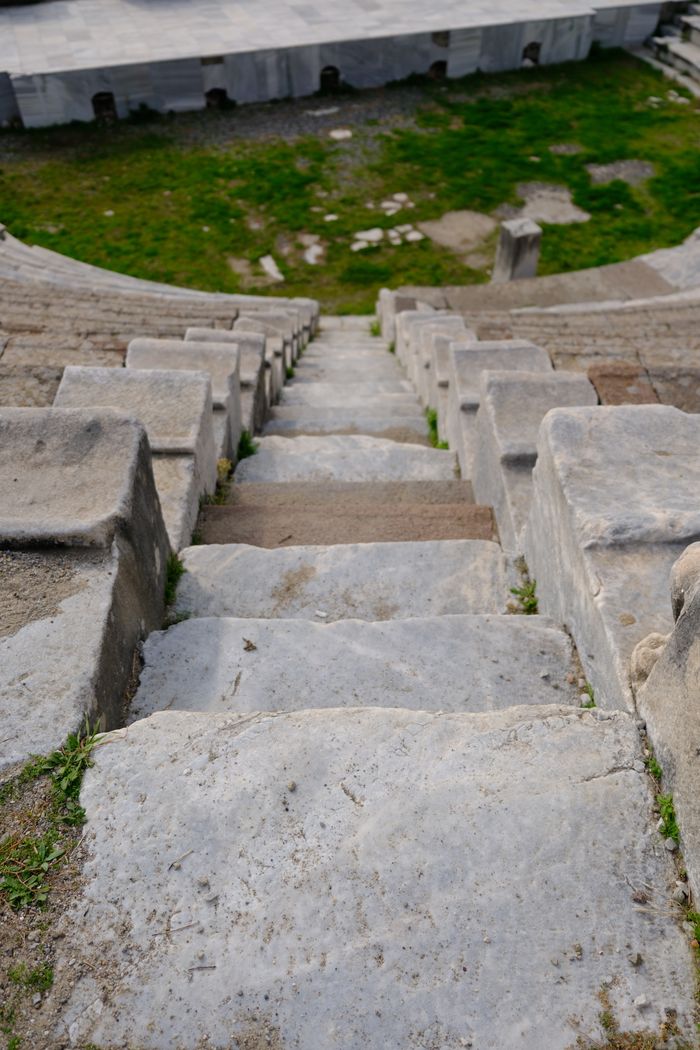 View of ancient stone steps descending into the Roman theater in Bergama, İzmir, Türkiye.