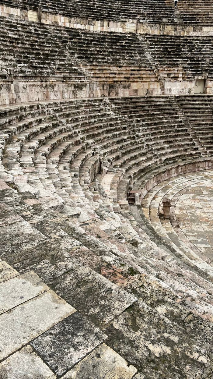 Explore the historic ruins of a Roman amphitheater in Jordan, showcasing stunning stone architecture.