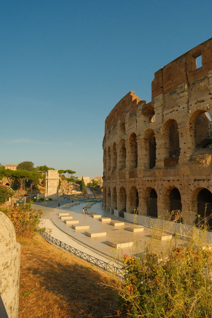Stunning sunset view of the ancient Colosseum in Rome, Italy.
